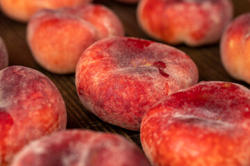 a pile of ripe washed peaches on the table