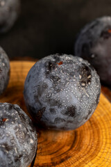 close-up of purple plum fruits in drops of water