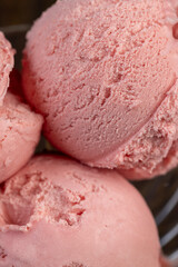 red strawberry-flavored ice cream in a glass bowl