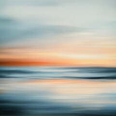 Fototapeta premium A soft, blurred sunset over the ocean creates a peaceful, dreamy atmosphere. The sky is a mix of pastel pinks, oranges, and blues, with the water reflecting the colors
