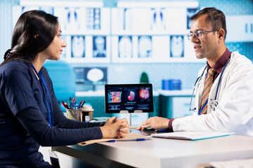 Physician meeting with a patient to discuss medical test results in a cabinet, using advanced diagnostic tools to interpret x ray scans, demonstrating a professional healthcare approach.