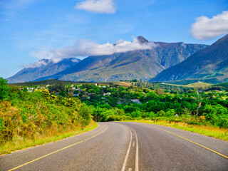 Road winding towards Swellendam town with Langeberg Mountains in the background, Western Cape, South Africa