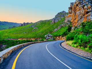 Road winding through Langeberg Mountains to Tradouw Pass under blue sky and white clouds, Suurbraak, Overberg, Western Cape, South Africa