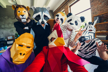 Portrait of panda rooster gorilla lion sloth zebra raccoon mask business people selfie v-sign...