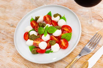 Popular snack of Italian cuisine is Caprese, made from tomatoes, mozzarella, basil and Pesto sauce