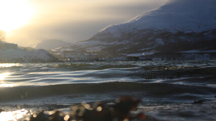 Winter landscapes in Norway showcase serene snowy mountains, icy fjords, and peaceful coastal views. Capturing the beauty of snow-covered trees, quiet roads, and glowing sunsets creates a sense of cal