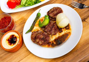 Turkish traditional kofte. Spicy kebab with pita and stewed vegetables