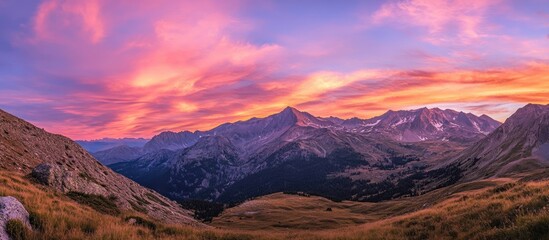 Fototapeta premium Majestic mountains under a vibrant sky showcasing breathtaking natural beauty and serene landscapes perfect for exploration and adventure