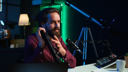 Content creator filming technology review of newly released DJ controller, unboxing it, excited to...