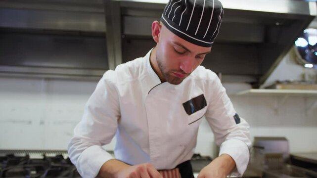 Sous Chef Is Preparing Swordfish In A Restaurant Kitchen