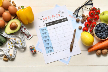 Blank meal plan and health food on table