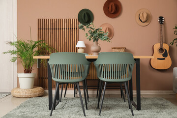 Interior of dining room with table, chairs and guitar