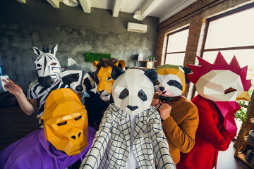 Portrait of panda rooster gorilla lion sloth zebra raccoon mask business people take selfie loft...