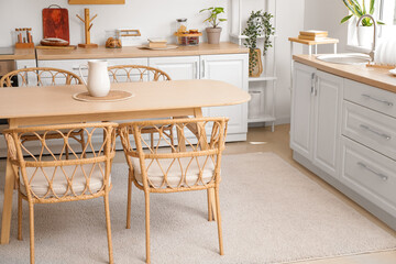 Dining table and chairs in interior of modern kitchen
