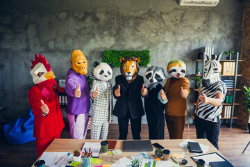 Portrait of panda rooster gorilla lion sloth zebra raccoon mask business people show thumb up loft...