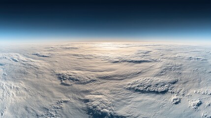 A breathtaking view of Earth's atmosphere from space, showcasing a vast expanse of clouds illuminated by the rising sun.