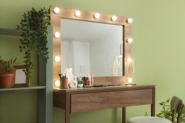 Interior of makeup room with glowing mirror, table and shelf unit