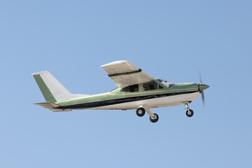 Fly by of a single engine aircraft. Painted green, black, and white, it has fixed gear and no lift...