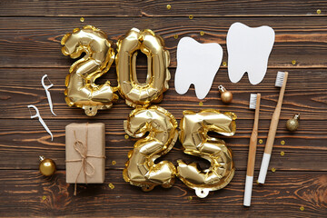 Figure 2025 with dentist's items and Christmas balls on wooden background