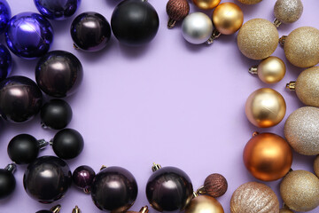 Frame made of different Christmas balls on pink background