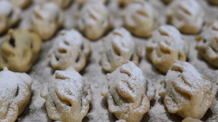 raditional Moroccan Mooncakes with Intricate Floral Pattern on Baking Sheet – Close-Up of Handmade Festival Cakes, Authentic Pastry Design, and Cultural Delicacies for Special Occasions