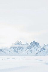 Expansive Winter Landscape Featuring Majestic Snow-Capped Mountains Under a Softly Diffused Sky