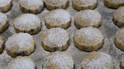 raditional Moroccan Mooncakes with Intricate Floral Pattern on Baking Sheet – Close-Up of Handmade Festival Cakes, Authentic Pastry Design, and Cultural Delicacies for Special Occasions