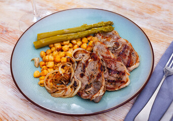 cuisine georgian roast lamb with beans and asparagus served on plate on wooden table