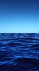 Obraz premium A serene view of calm ocean waters under a clear blue sky.