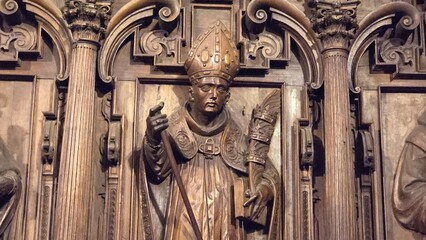 Wooden carved image of a Catholic bishop holding a staff