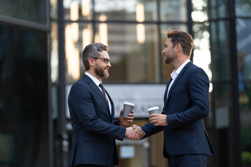 Businessmen handshaking after contract deal. Successful agreement in business deal. Businessmen dealing outdoor. Partnership concept. Handshaking. Business partnership. Business deal. Copy space