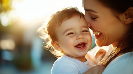 This heartwarming image of a mother sharing laughter with her baby captures the essence of joyful family moments and the special bond shared together.