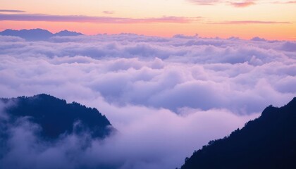 view of a mountain range with a few clouds