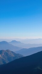 Fototapeta premium mountains in the distance with a blue sky and a few clouds