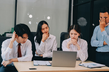 Frustrated upset multiracial business team people sad with bad work result in report disappointed in corporate bankruptcy failure crisis worried of paperwork problem sit at table at office meeting