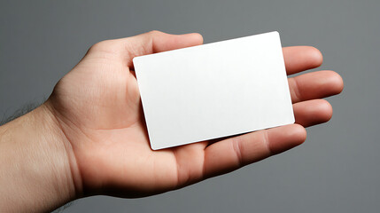 Obraz premium A professional businessman’s hand presenting a blank white business card