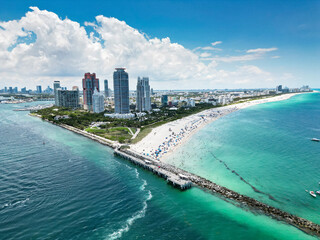 Naklejka premium Miami Beach scene from drone, Florida, USA. Miami seaside. Aerial view of Miami Beach and cityscape. Coastline of Miami Beach, aerial view. Famous American landmarks.
