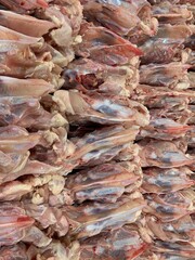 Pile raw Chicken frame on market stall 