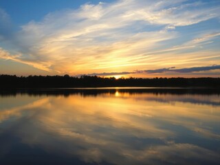 A serene dusk scene at a tranquil lake with the sun setting in the background, casting a warm glow over the water and reflecting colorful hues in the sky, scenery, lake