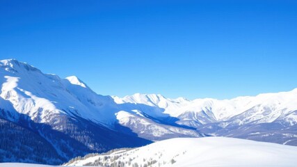 Obraz premium Snow-covered mountain range under a clear blue winter sky, travel, scenic