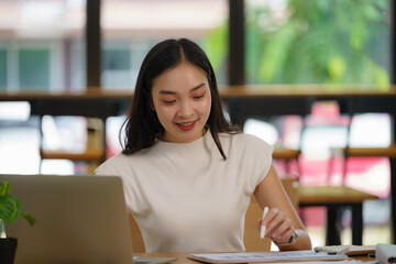 Asian businesswoman working with a laptop at the office.