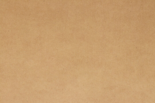 Brown cardboard sheet abstract background, texture of sepia color kraft paper with vintage pattern for design art work.