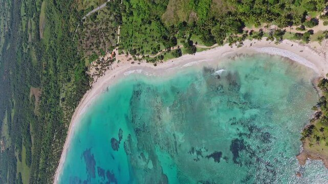 Vertical drone shot over the Playa los Coquitos beach in sunny Dominican Republic