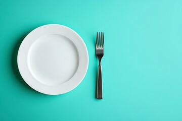 Empty White Plate and Fork on Teal Background