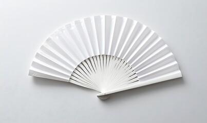 White folding hand fan set apart against a white background