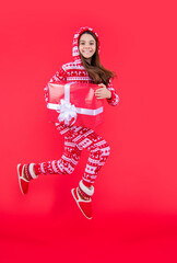 merry christmas. glad teen girl with red christmas present in studio. teen girl hold present