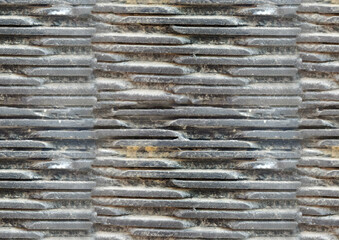 Rustic gray stone tile texture, layered stone wall with metallic sheen, natural and earthy tones in a structured pattern.