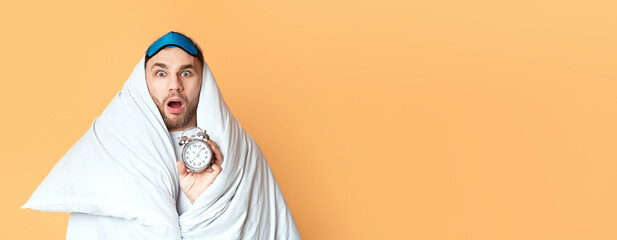 Young man does not want get up for work on yellow background