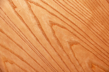 Light brown wood texture with a diagonal grain pattern. Wood is smooth and polished, perfect for use as a background