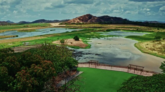 Aerial drone shot over la Hacienda el Viejo Wetlands in Guanacaste, Costa Rica. High view of the lush vegetation and the green landscape.